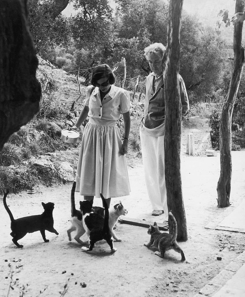 Robert Graves watches his wife Beryl feeding cats in Deya, Majorca, January 1954.