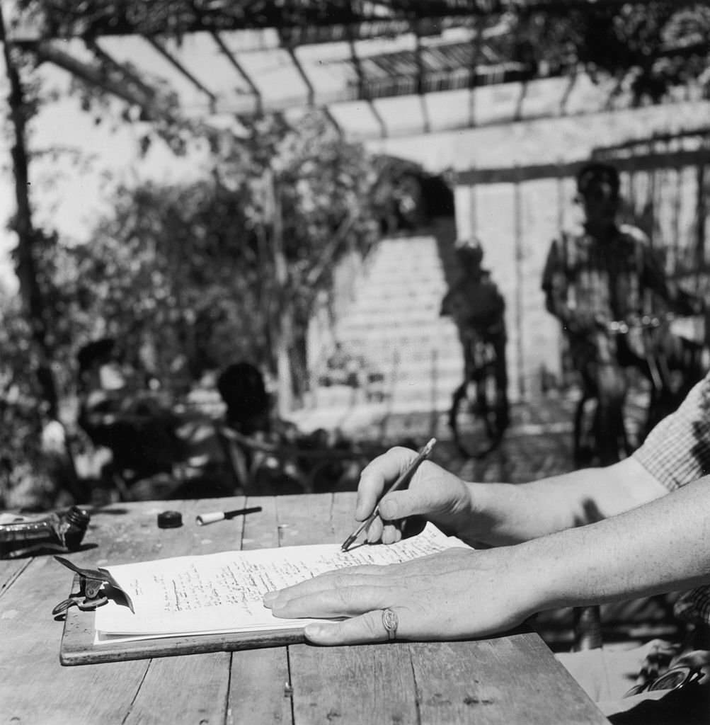 Robert Graves writing at his home in Deya, Majorca, January 1954.