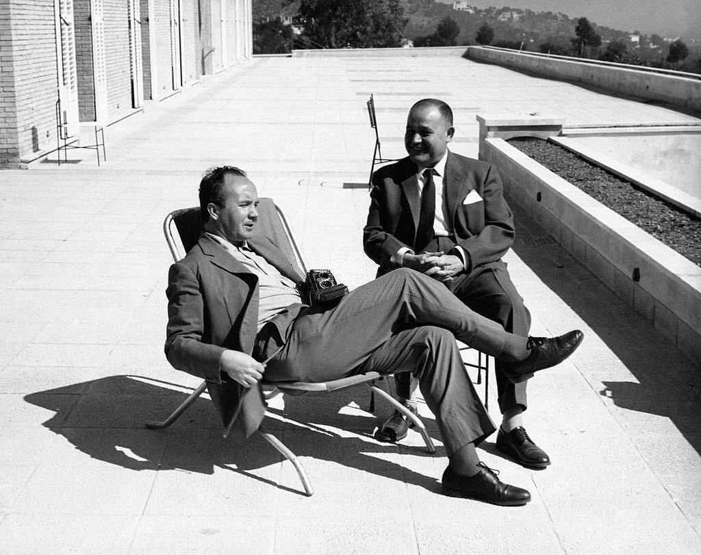 Italian photographer Mario De Biasi sitting on the deckchair of a terrace with his camera in his hand. Palma de Mallorca.