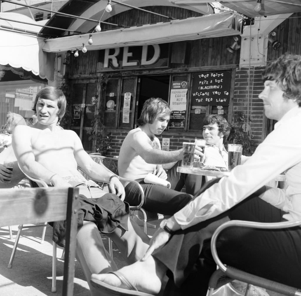 Derby County players in Majorca as they celebrate their League Titile win. Having a few pints in the Red Lion in Magaluf, 29th April 1975.