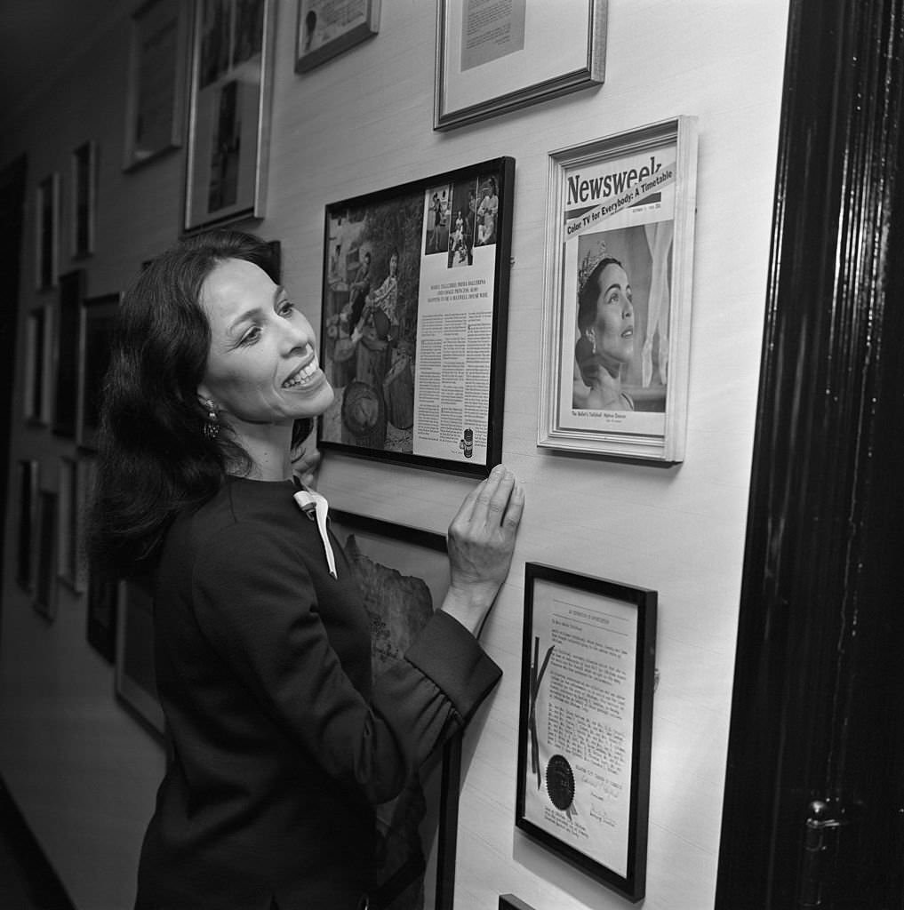 Ballerina Maria Tallchief at home looking over mementoes of her past career.
