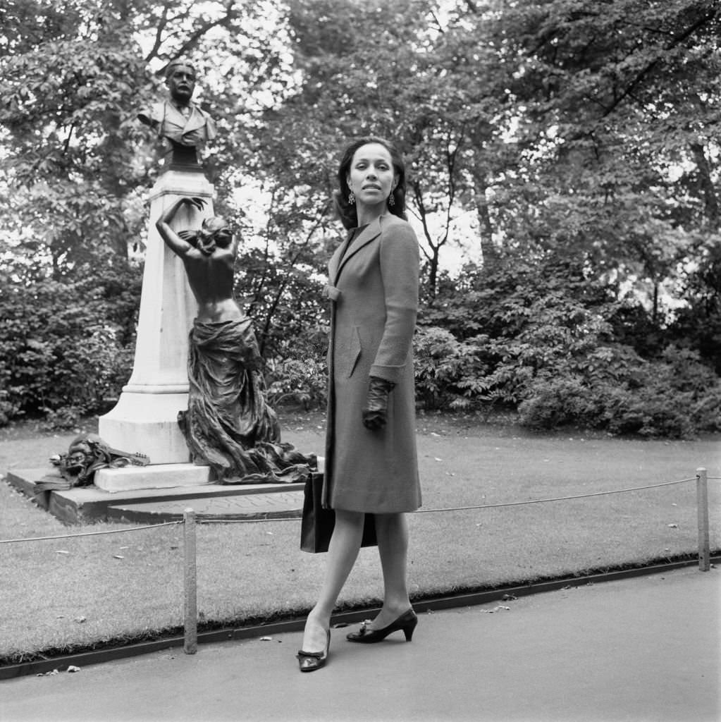 Maria Tallchief in Victoria Embankment Gardens, London, next to the memorial of composer Arthur Sullivan, 28th August 1965.