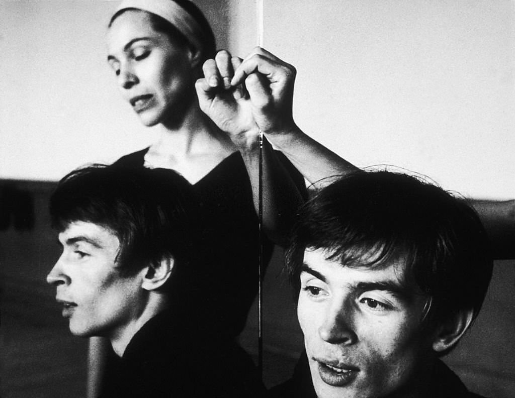 Maria Tallchief and Rudolf Nureyev are reflected in a mirror in a dance studio.