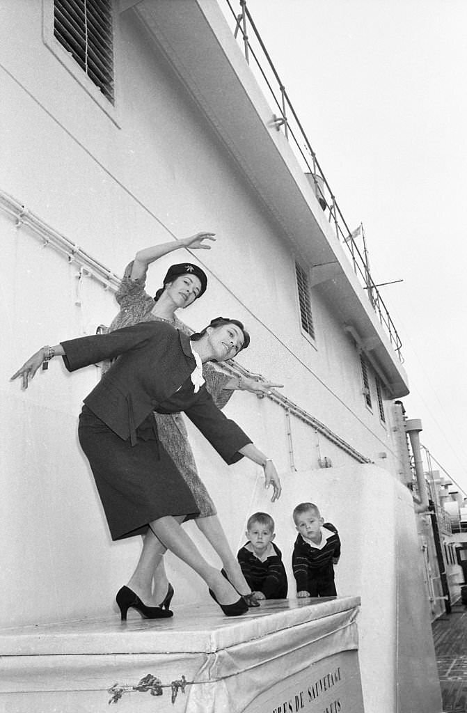 Ballet dancers Marjorie (hat), and Maria Tallchief perform a sister act upon their arrival in New York aboard the liner Liberte.