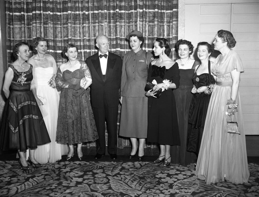 President Dwight Eisenhower talks with the winners of the women of achievement awards at the Annual Dinner of the Women's National press Club in Washington last night.