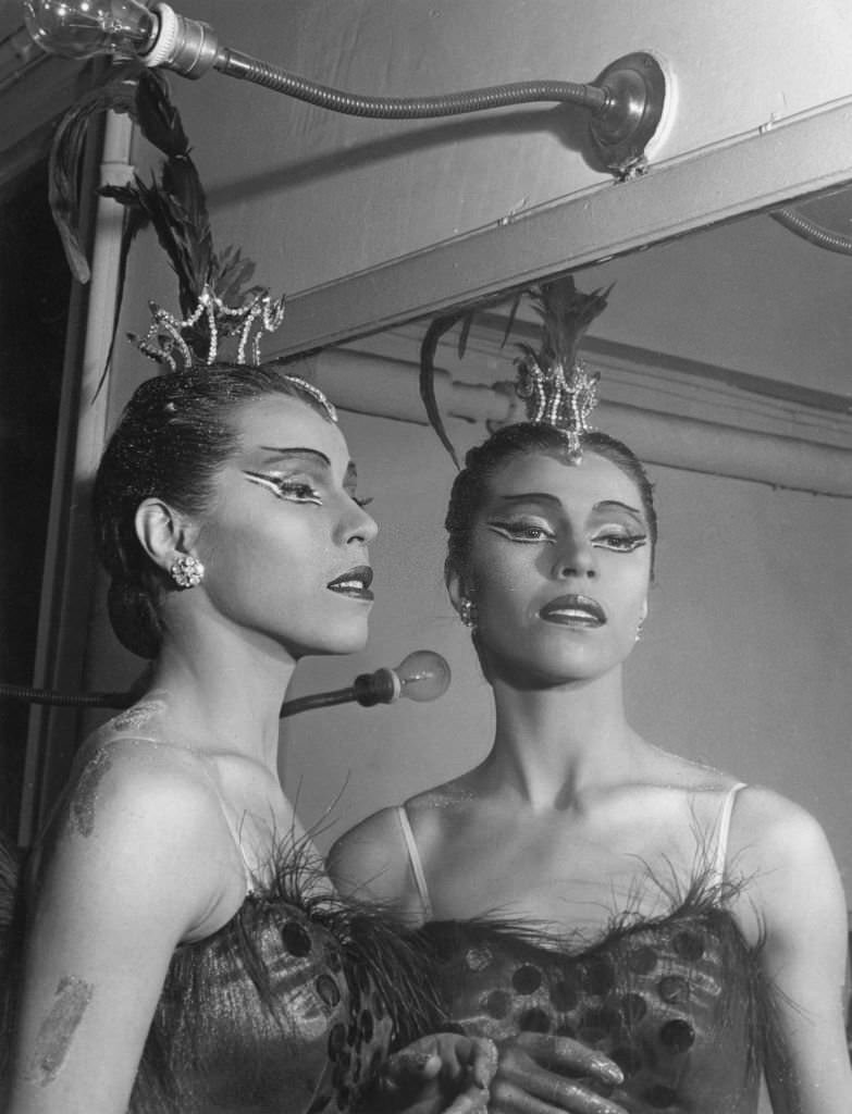 Maria Tallchief near a mirror wearing ballet costume and make-up for choreography 'Firebird', 1950