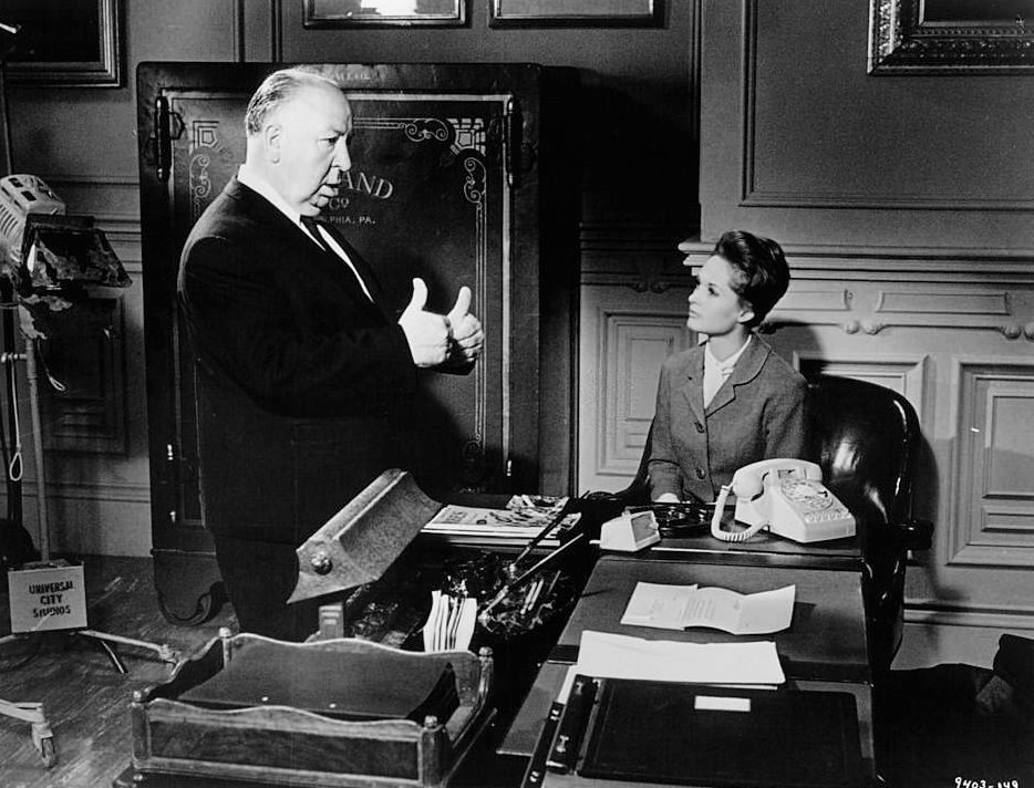 Alfred Hitchcock gives Tippi Hedren directions in between scenes from the film 'Marnie', 1964.