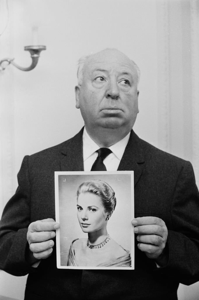 Alfred Hitchcock holds up a photographic print of actress Grace Kelly in November 1964.
