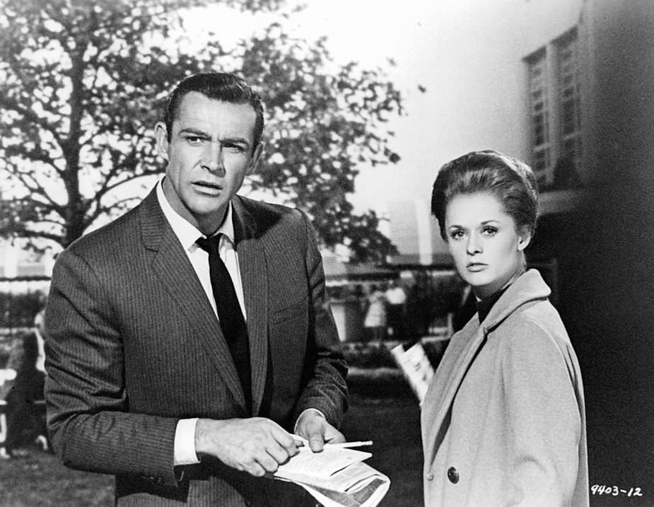 Tippi Hedren is handed documents from Sean Connery in a scene from the film 'Marnie', 1964.