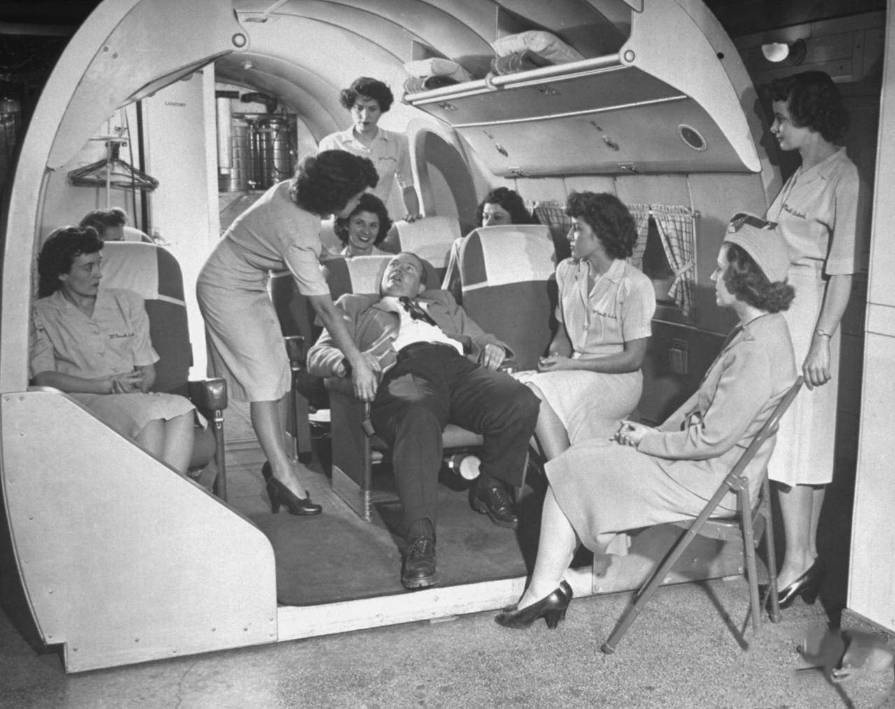 Students at the McConnell Air Hostess School learning how to deal with inebriated passengers.