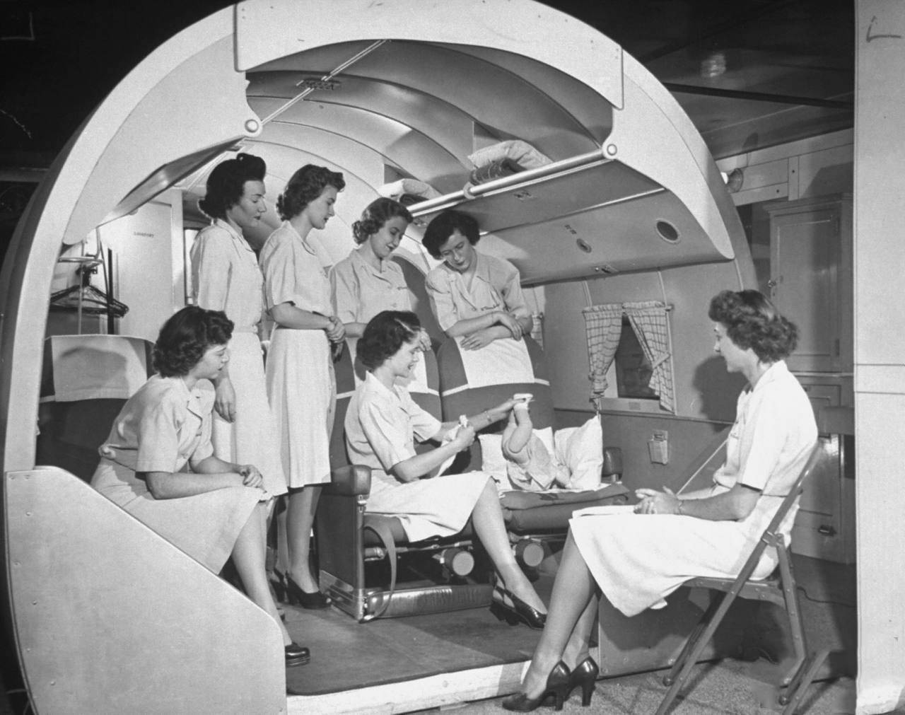 Students at the McConnell Air Hostess School learning how to change a baby.