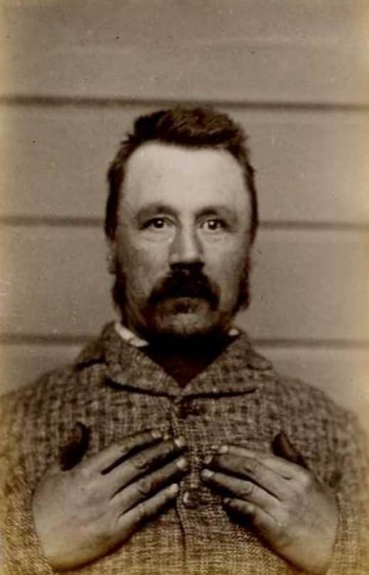 David Kirk Rhodes (b. 1847, England). Charged with 9 counts of embezzlement and sentenced to 3 years on April 4, 1887 (Dunedin). Photograph taken on July 11, 1889.