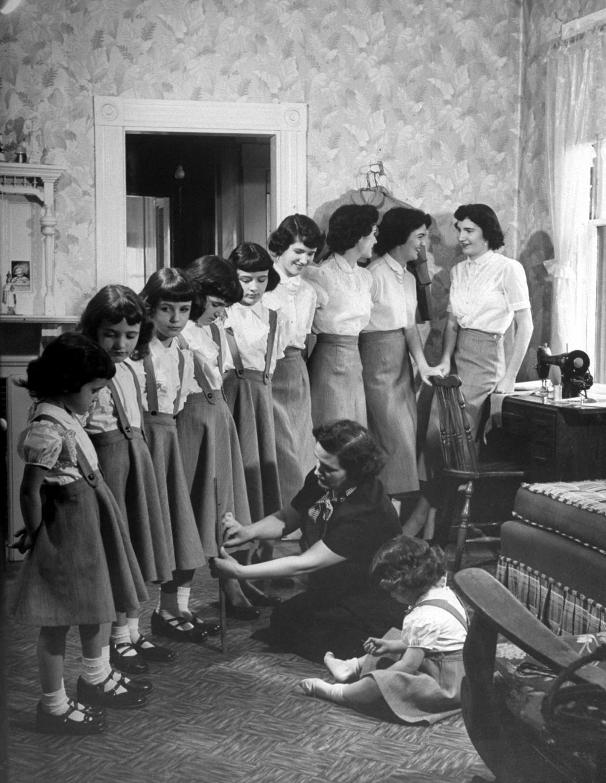 Mrs. O’Neil pinned up hems on all ten of her daughters’ dresses in preparation for Easter, 1952.