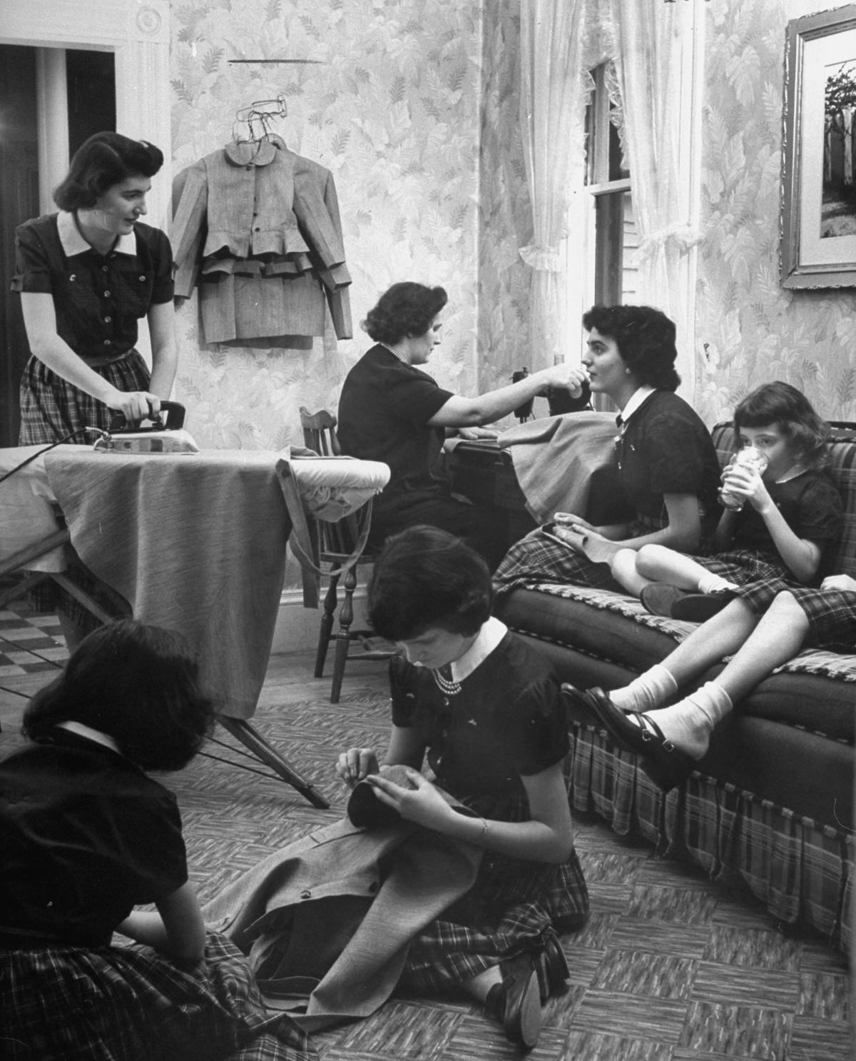 One of the sisters, Jane, ironed a skirt while her mother and sisters worked another suit in preparation for Easter, 1952.