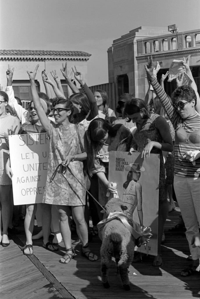 On the Atlantic City Boardwalk, demonstrators, one of whom holds a live sheep on leash, holds up 'V' signs as they protest the Miss America beauty pageant, Atlantic City, New Jersey, September 7, 1968.
