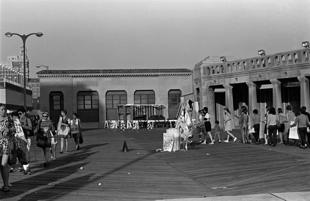 On the Atlantic City Boardwalk, demonstrators, many with posters, protest the Miss America beauty pageant, Atlantic City, 1968.