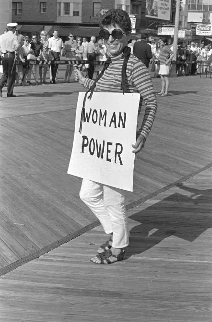 A demonstrator carries a poster that reads 'Woman Power' as she protests the Miss America beauty pageant, Atlantic City, 1968.