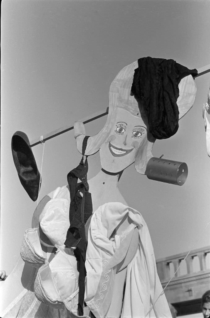 A Miss America marionette draped in underwear, high heels, and hair curlers during a protest of the Miss America beauty pageant on the Atlantic City Boardwalk, Atlantic City, 1968.