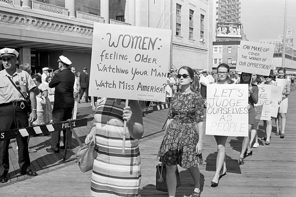 Demonstrators picketing the Miss America Pageant are shown as they await the hour when the new Miss America will be named.