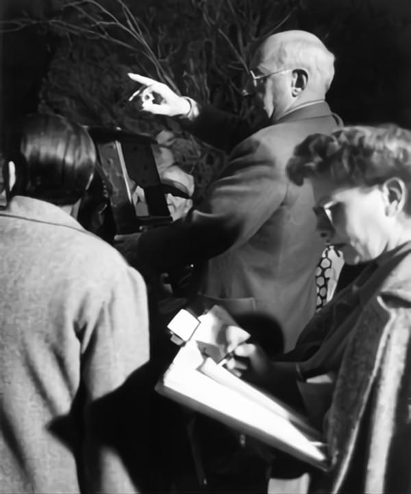 Cecil B DeMille on set candid with Cinematographer George Barnes and Script Supervisor Claire Behnke on-set of the Film 'Samson And Delilah', 1949