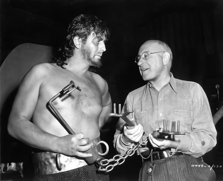 Victor Mature and Cecil B DeMille pose with Prop Ancient Keys on set candid during filming of 'Samson and Delilah', 1949