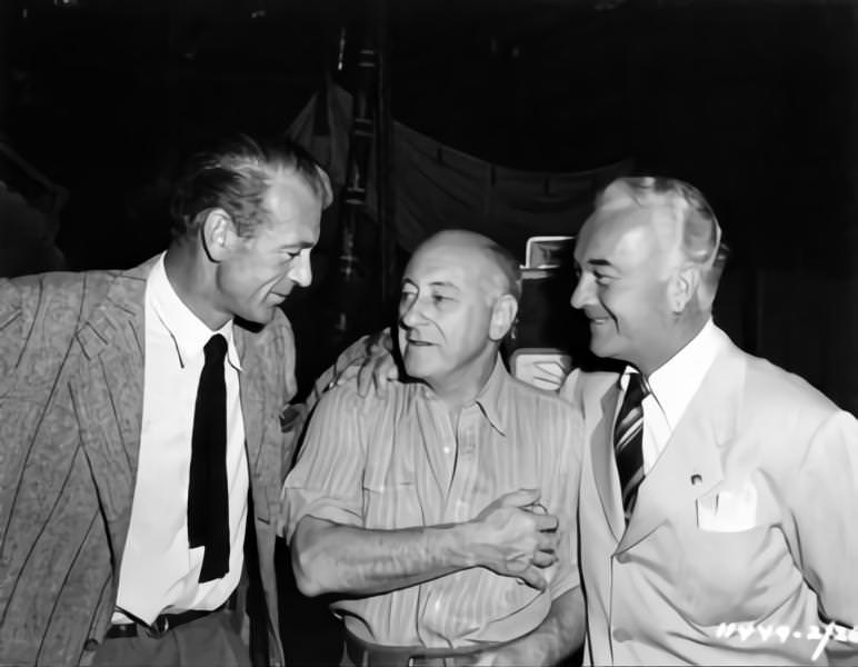 Cecil B DeMille (centre) on set candid with Set Visitors Gary Cooper and William Body during filming of 'Samson and Delilah', 1949