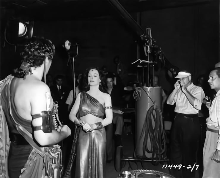 Victor Mature and Hedy Lamarr, Cecil B DeMille  and Cinematographer George Barnes on set candid during filming of 'Samson and Delilah', 1949