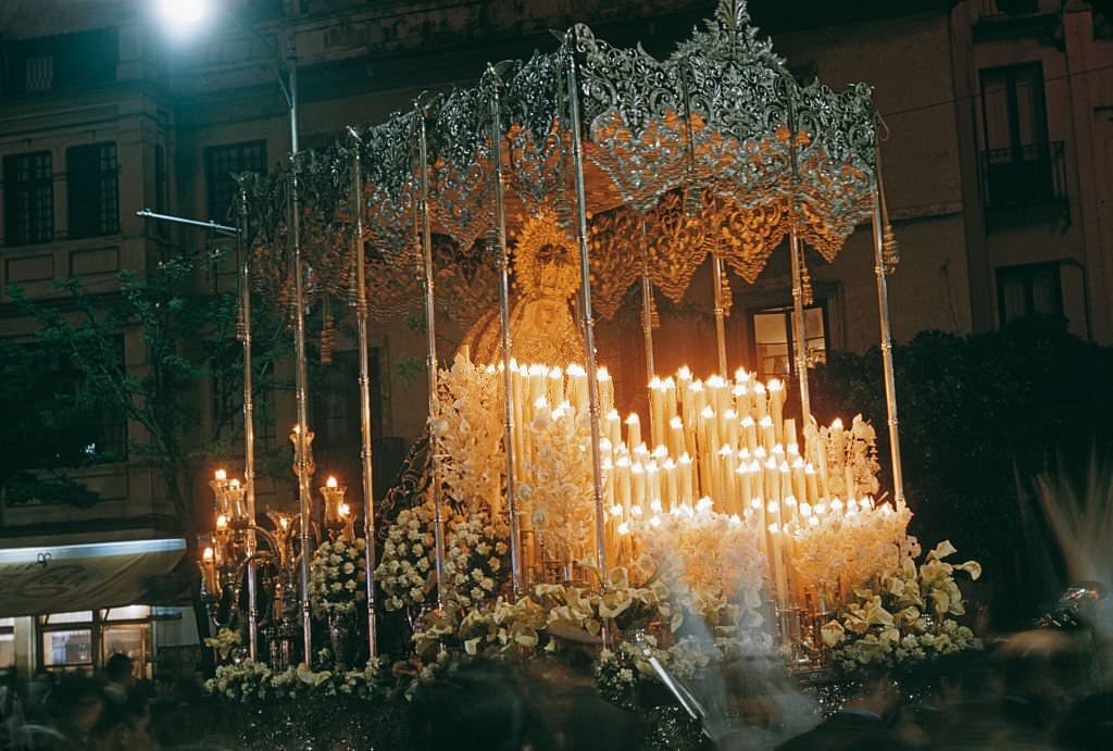 A paso or float surmounted with an effigy of the Virgin Mary during Semana Santa or Holy Week in Spain, probably Seville, 1960.