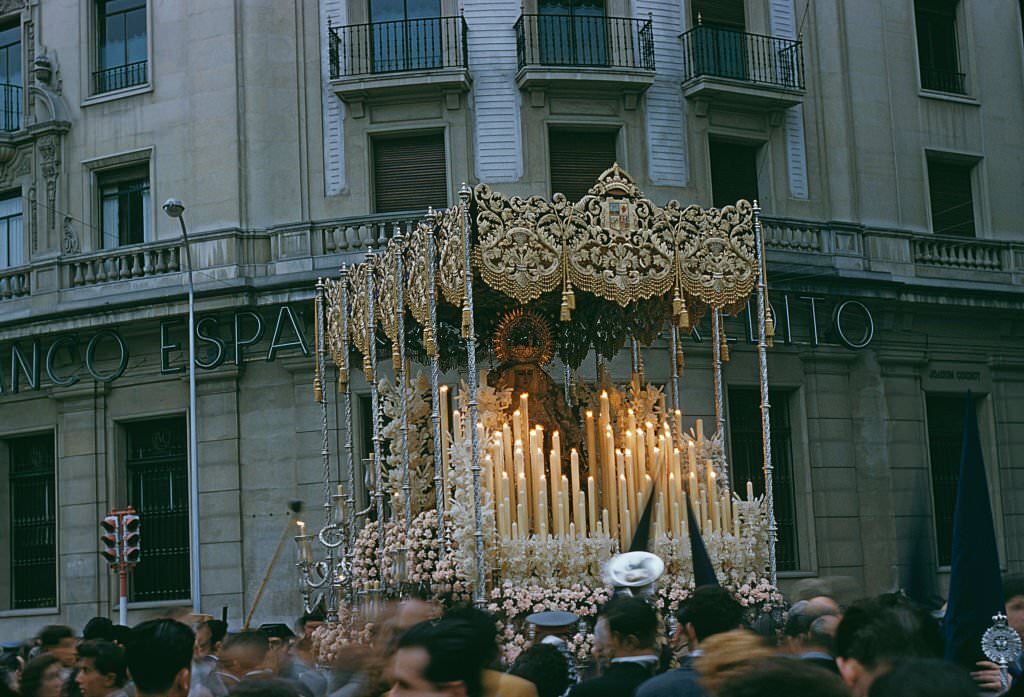 A paso or float surmounted with an effigy of the Virgin Mary during Semana Santa or Holy Week in Seville, Spain, circa 1960.