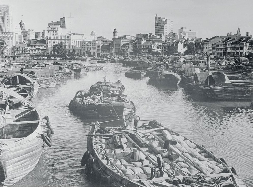 A typical Singapore River scene with the large commercial houses in the background, 1960s