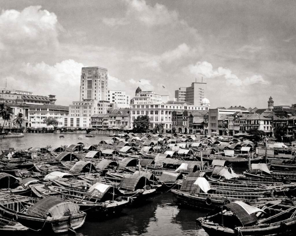 City Buildings Skyline Seen Across Bumboat Cargo Barges Moored in Harbor Singapore, 1960