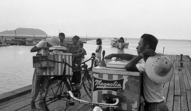 A couple of ice cream sellers on a jetty in Northern Singapore, possibly Sembawang, 1960s