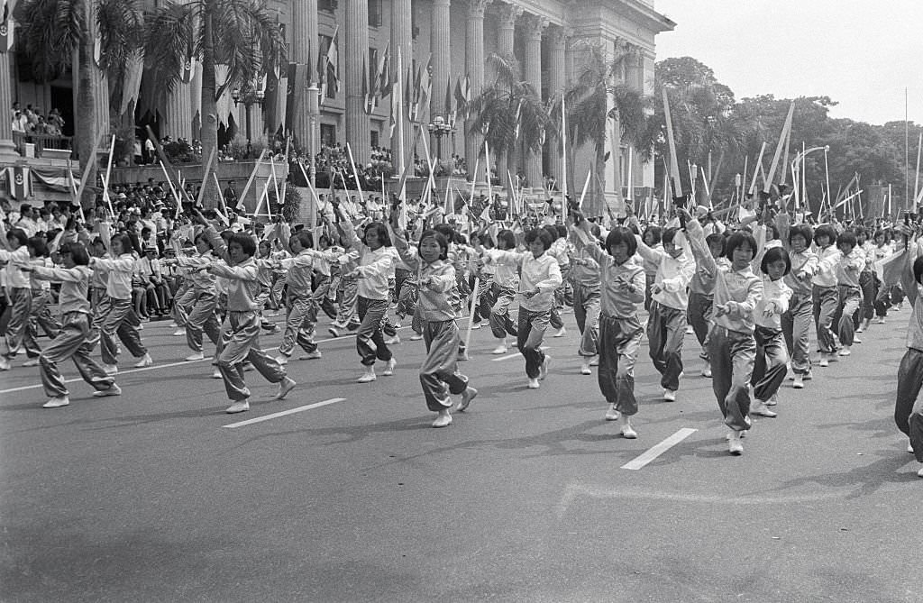 The Island Republic of Singapore celebrated its second Independence Day Anniversary with a mammoth parade before City Hall by some 25,000 persons. Here, young girls perform a colorful sword dance, Singapore, 1960s