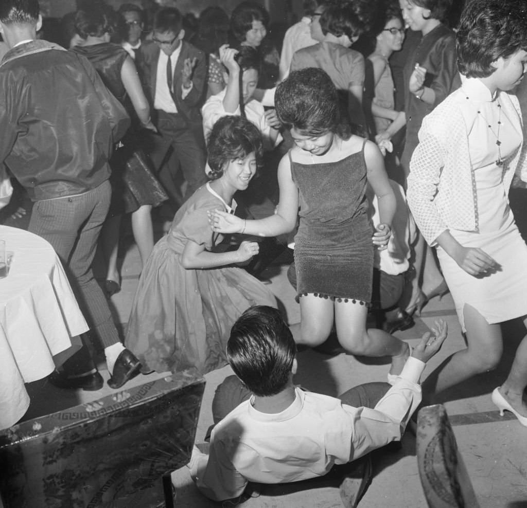 People dancing the twist in the Celestial Room of the Amber Mansion, a nightclub in Singapore, 1963