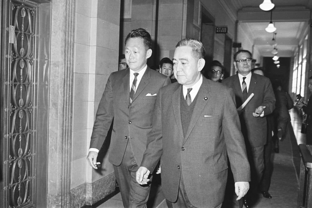 Singapore Prime Minister Lee Kuan Yew and Japanese Prime Minister Eisaku Sato walk a corridor of the Diet on March 20, 1967