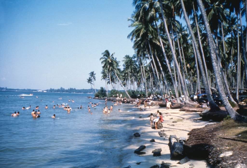 People relaxing on a Singapore beach, 1962