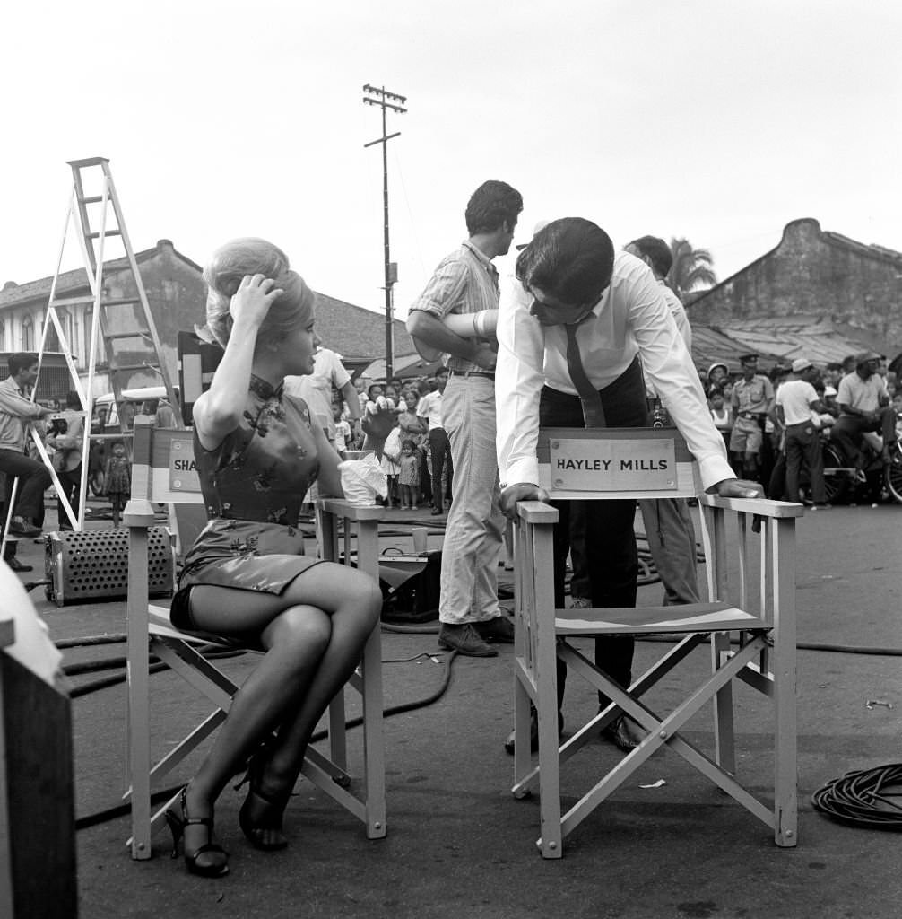 A new-look Hayley Mills in Chinese Make-up and a cheongsam on location in Singapore, for her new film 'Pretty Polly'.