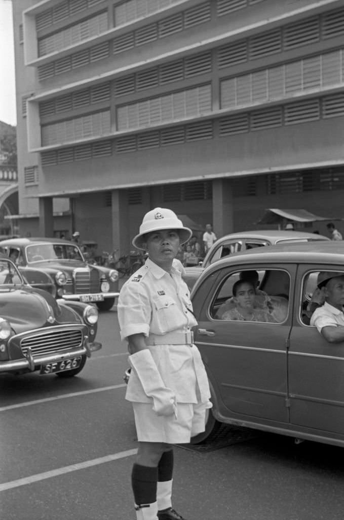 Traffic policeman directing traffic in a street of Singapore, 1962