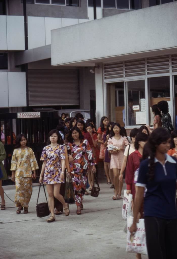 Workers leaving the 'Rollei' camera factory in Singapore in the 1970s.