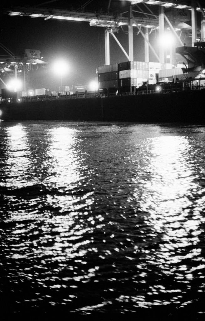 Cranes and containers on the illuminated docks of Singapore's commercial port, 1989