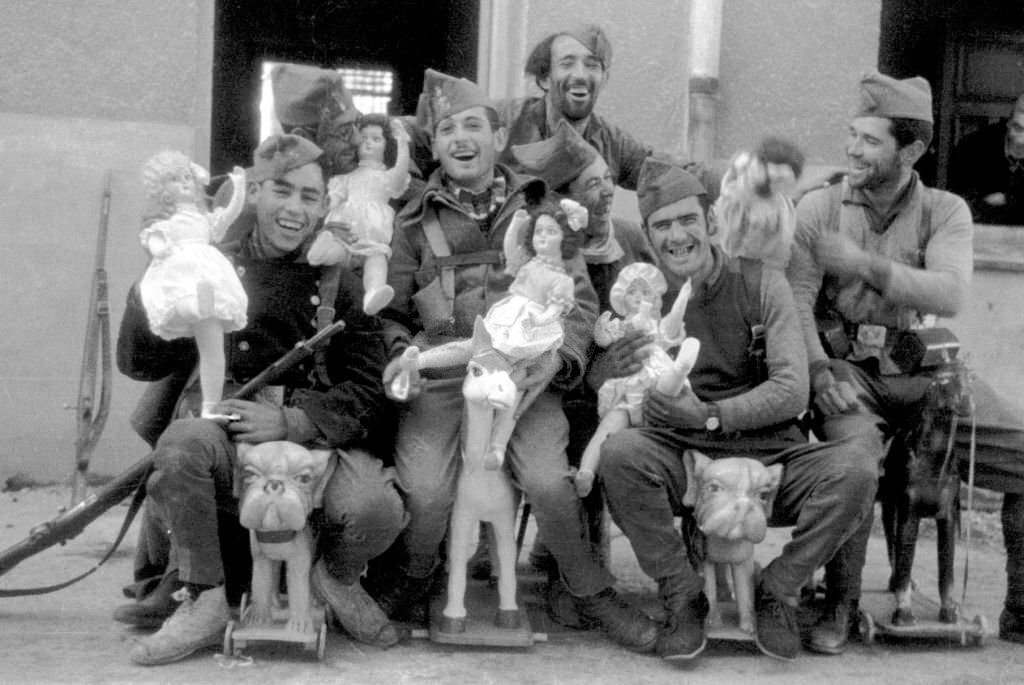 A group of soldiers posing with dolls, 1936