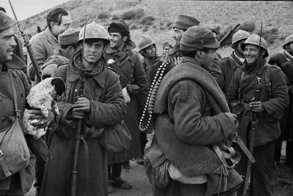 Writer and journalist Ernest Hemingway talks with Republican soldiers before they go into action on the Aragon front during the Spanish Civil War at the Battle of Teruel on 21st December 1937 near Teruel, Aragon, Spain.