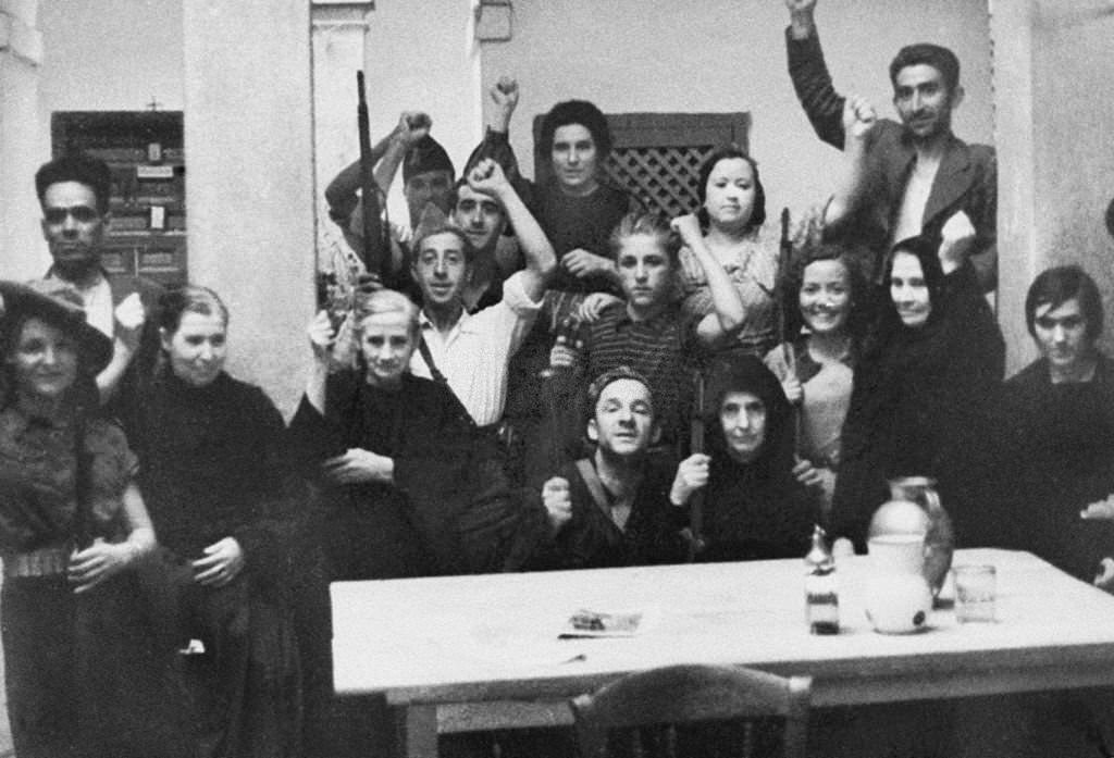 A group of nuns in civilian clothes, protected by governmental militimen in a Toledo's convent, during the Spanish civil war.