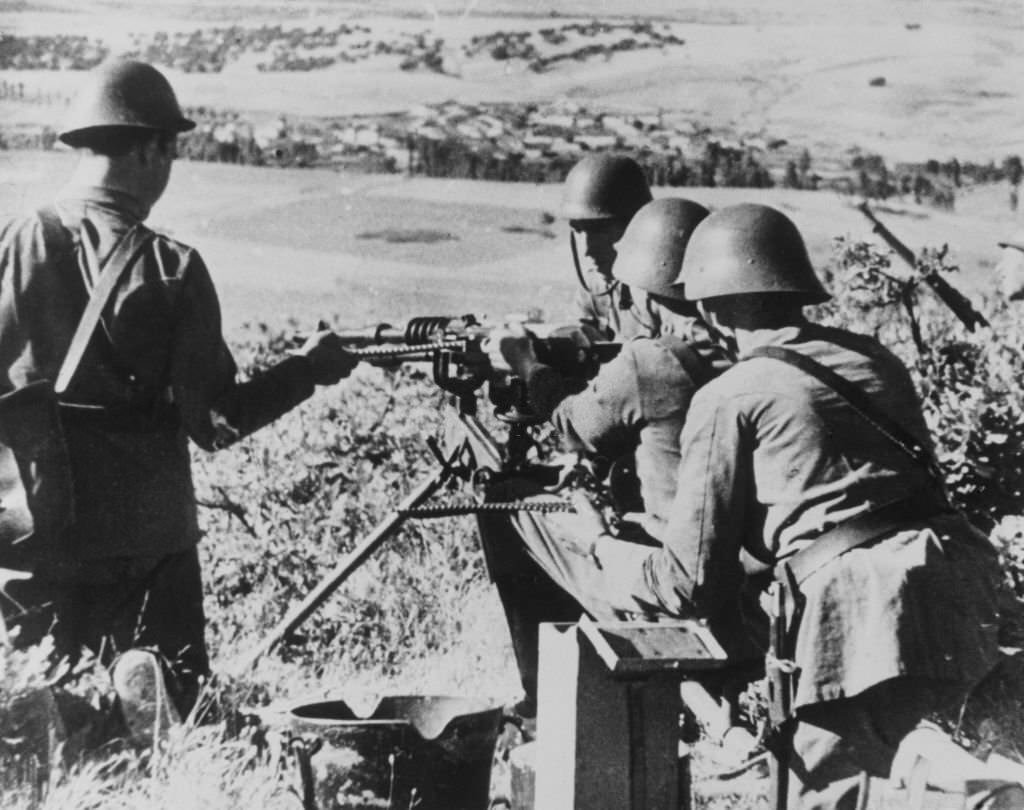 A machine-gun nest, manned by rebels in steel helmets in the Guadarrama Mountains north of Madrid, Spain, July 30th, 1936.