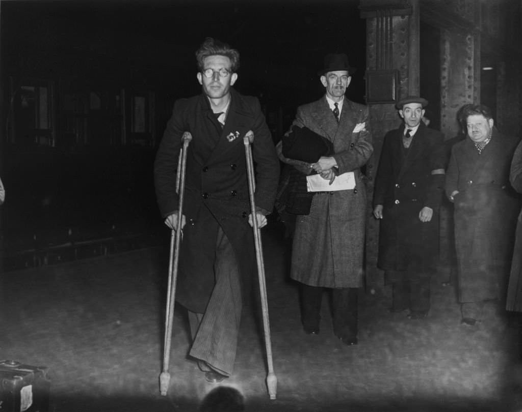 A wounded member of the International Brigade returns to Victoria Station, London, 19 December 1938