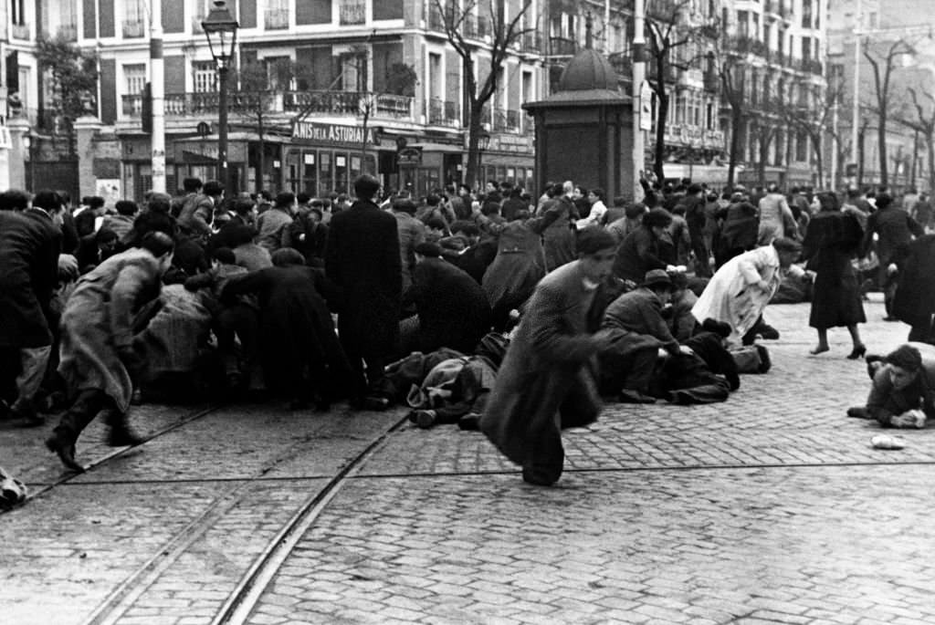 Demonstrators run during a violent demonstration in the streets of Madrid ahead of the February 16, 1936 parlimentary elections that saw the rise to power of the Frente Popular.