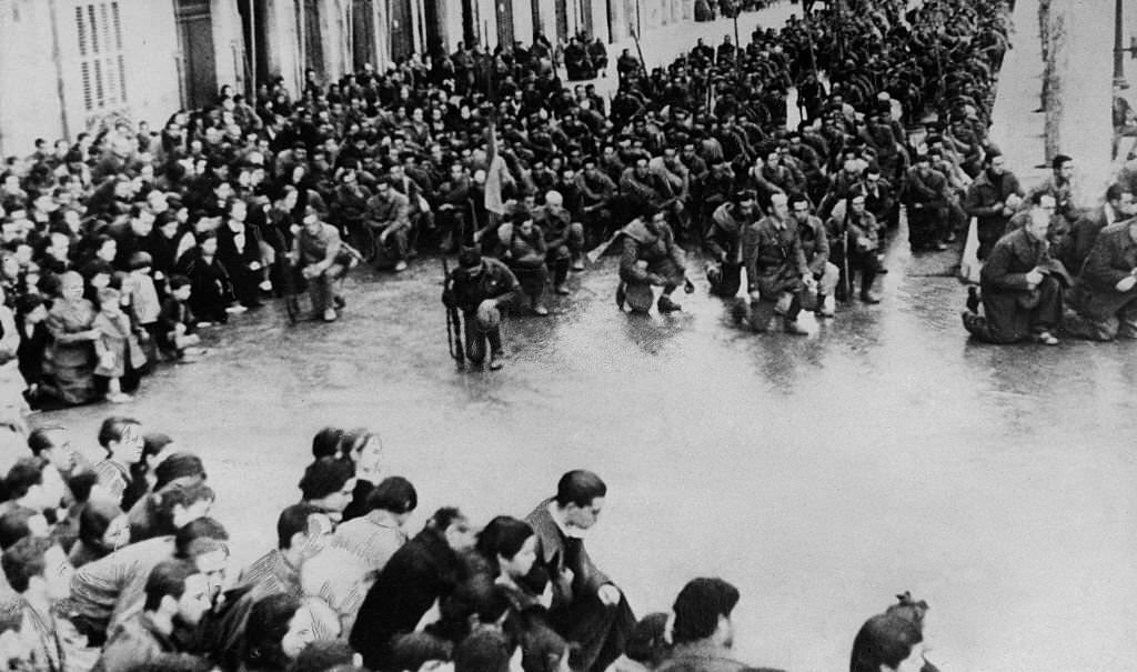 Spain Catalonia Tarragona: Spanish Civil War: after conquering the city members of the 5th division of Navarra are kneeling down in prayer during a thanksgiving service in the streets of Tarragona, 1939