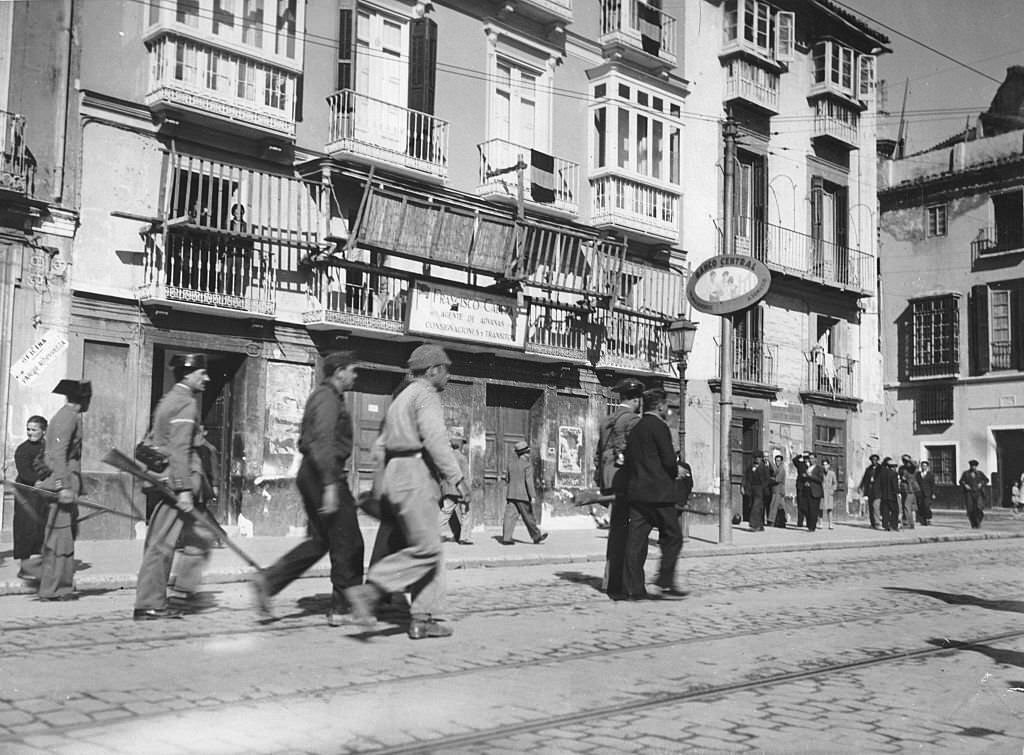 Spanish Civil War Supporters of the Republicans are led away after the capture of the city by the Nationalists on 7 February 1937