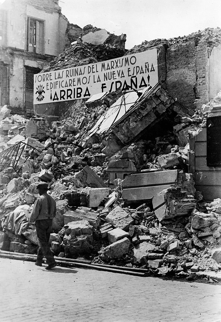 Spanish Civil War Propaganda banner at a ruined building after the capture of the city by the Nationalists on 7 February 1937,
