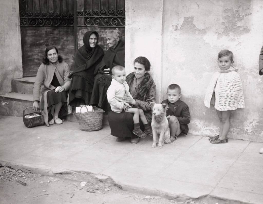 Scenes outside the Barcelona Milk Depot where hungry women and children queue up daily for their milk ration, 1937